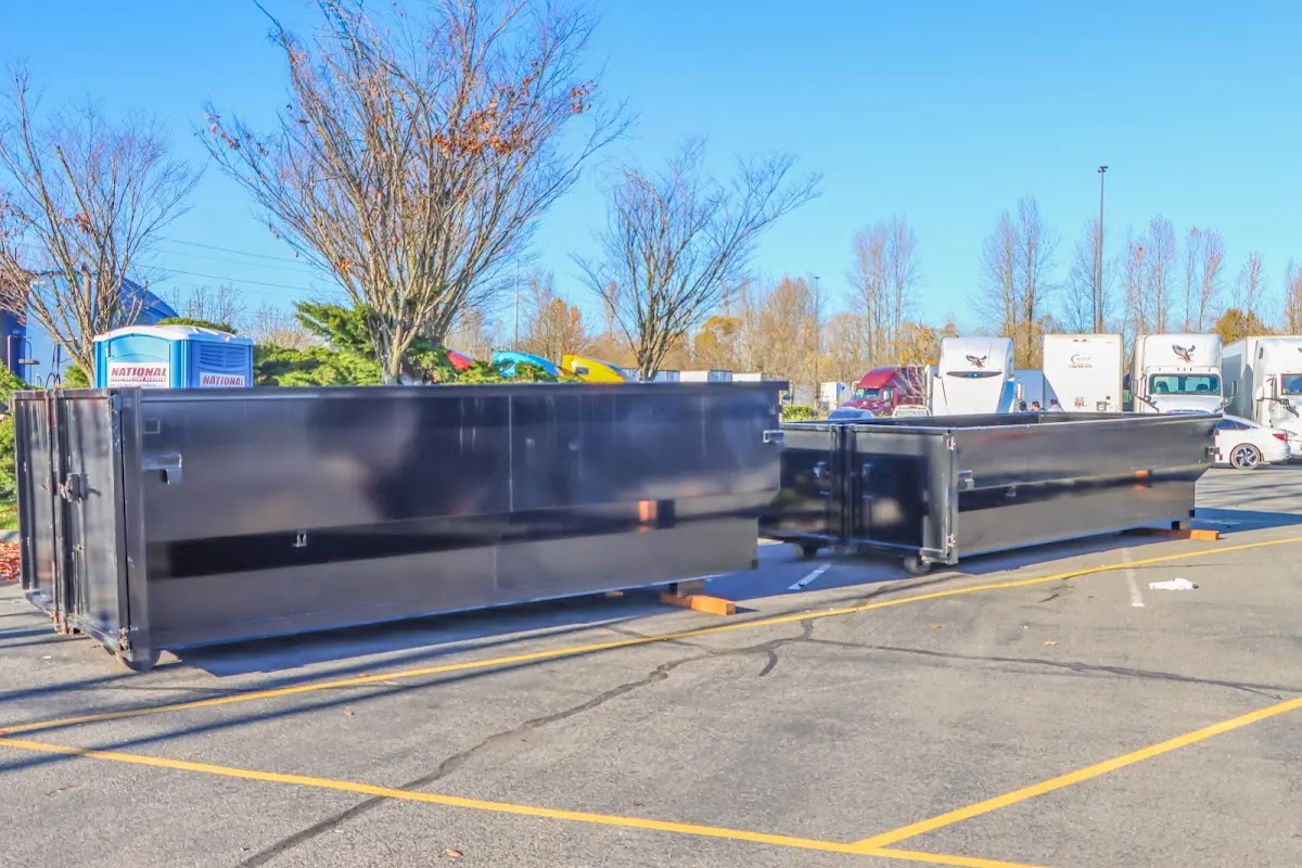 Professional dumpster rental service with roll-off container on residential driveway in Royse City